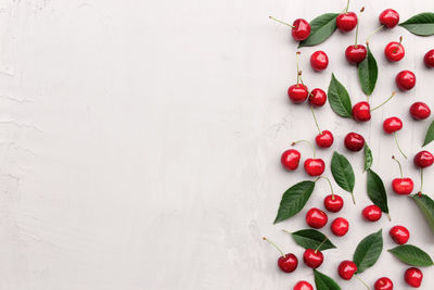 Directly above shot of strawberries on table against white background