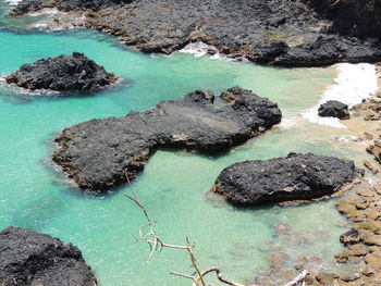 Close-up of rocks on shore against sky