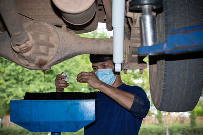 Portrait of man working on motorcycle