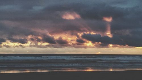 Scenic view of sea against cloudy sky