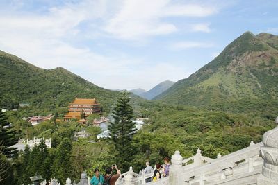 People on mountains against sky