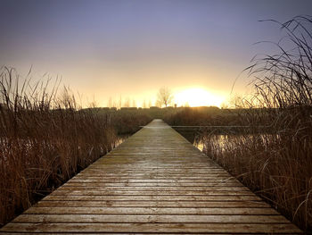 View of empty footpath during sunset