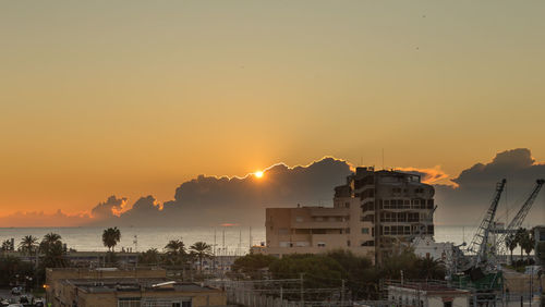 Buildings against sky during sunset