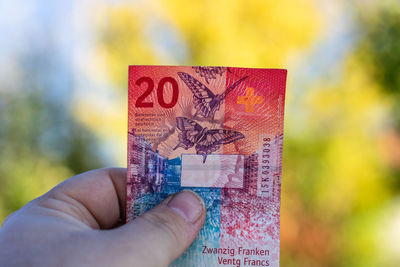 Cropped hand holding paper currency