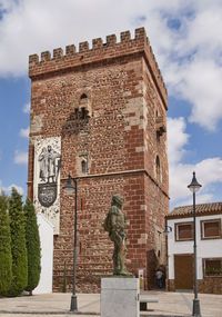 Statue of historic building against cloudy sky