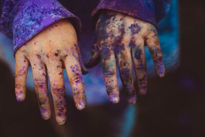 Cropped hands with powder paints