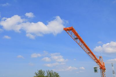 Low angle view of crane against sky