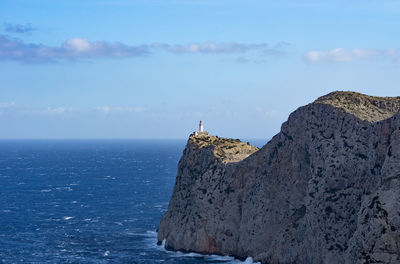 Rock formations by sea against sky