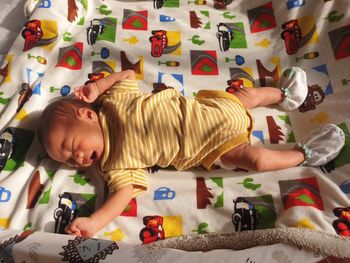 High angle view of boy sleeping on bed