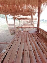 Close-up of empty bench on beach