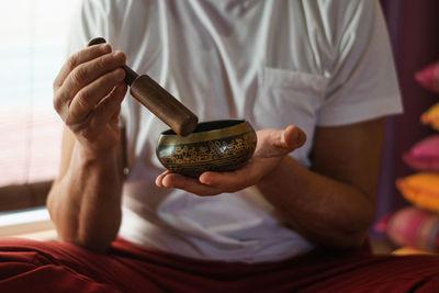 Close-up of man holding hands on bed