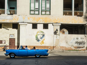 Cars on street against building in city