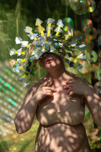 Portrait a woman in a reflective mask in a beige bikini on a cd / dvd case of scenery in the forest