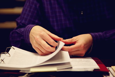 Cropped hand turning pages