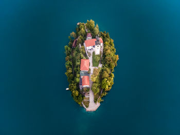 Aerial view of cerkev marijinega, a catholic church on a small island in the middle of bled lake