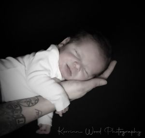 Portrait of cute baby boy over black background