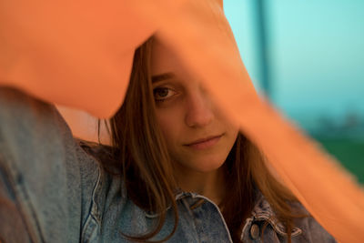 Portrait of woman wearing orange textile outdoors