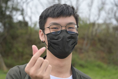 Man gesturing while mask during pandemic