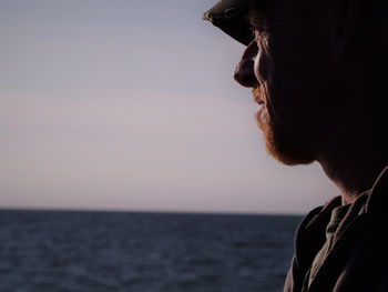 Close-up of man against sea