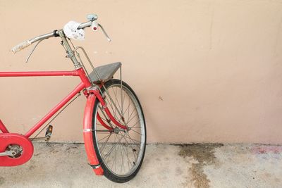 Bicycle parked against wall