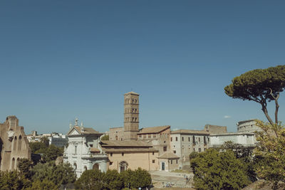 Buildings against clear blue sky