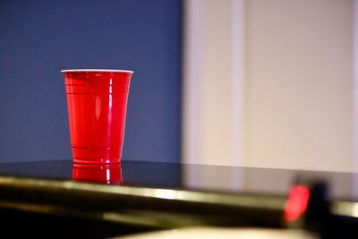 Close-up of red wine glass on table