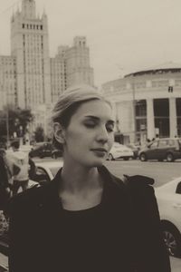 Portrait of young woman in city