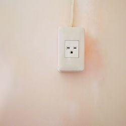 Close-up of electrical outlet on wall at home