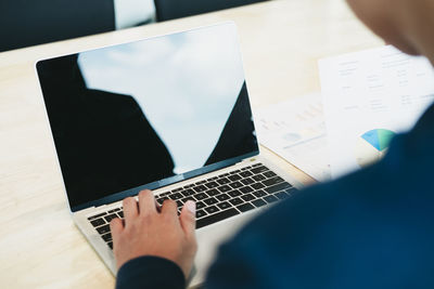 High angle view of man using laptop on table