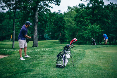 Man with umbrella on golf course