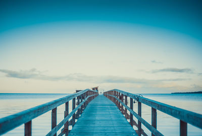 Pier over sea against sky