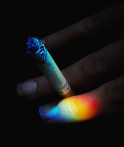 Close-up of human hand against black background