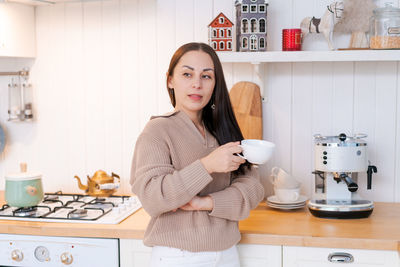 Concept festive christmas atmosphere, cute woman drinking tea or coffee