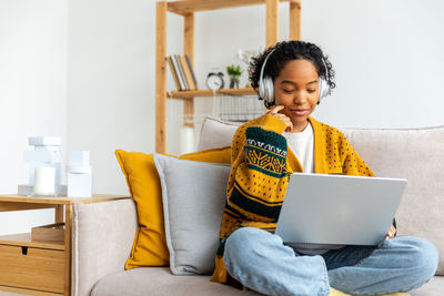 Young woman using laptop at home