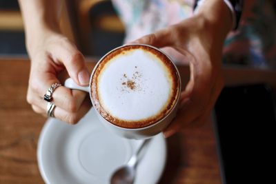 Midsection of woman holding coffee cup