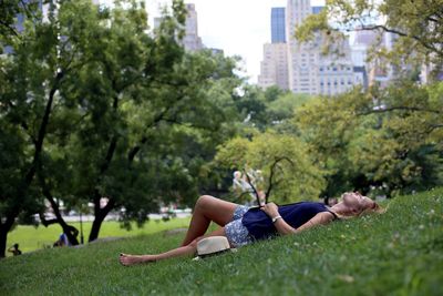 Side view of young woman relaxing in park