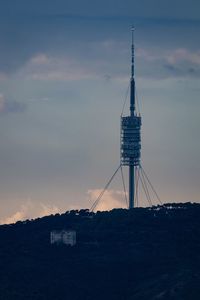 Communications tower against sky during sunset