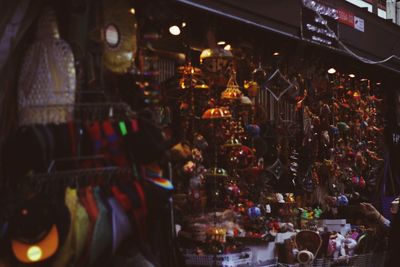 People at illuminated market stall