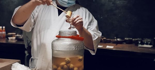 Midsection of man holding water