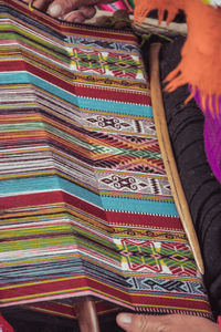 Low section of person on multi colored wall