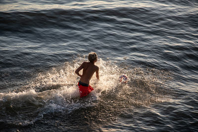 Full length of shirtless man in sea