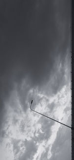 Low angle view of airplane flying against sky