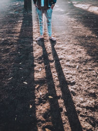 Low section of woman standing on street