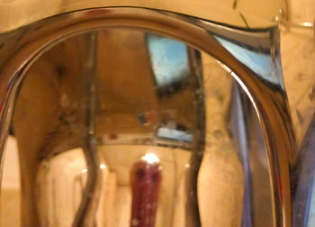 Close-up of wine glass with bottles