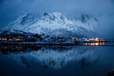 Scenic view of illuminated snowcapped mountains against sky