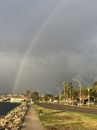 Scenic view of rainbow over landscape against sky