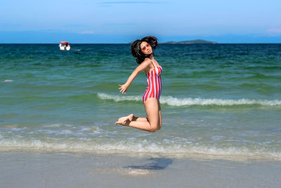 Woman on beach against sky