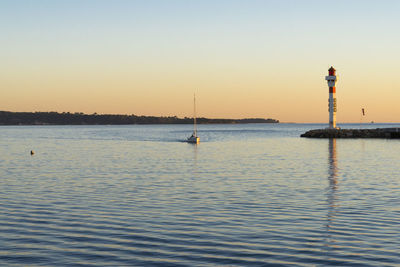 Scenic view of sea against clear sky during sunset