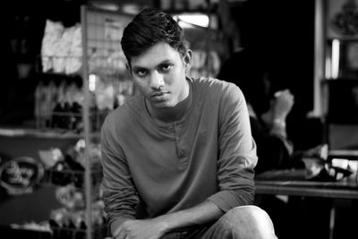 Portrait of young man sitting outdoors