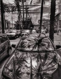 Close-up of cars against sky in city